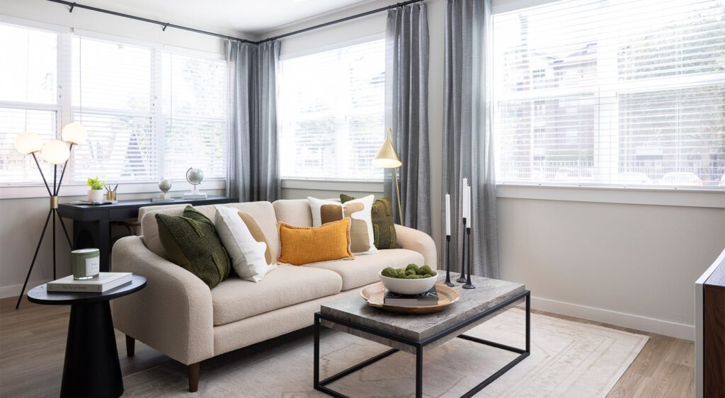 Clean and furnished bedroom available for rent in a Houston home, featuring a bed, nightstand, and natural lighting.